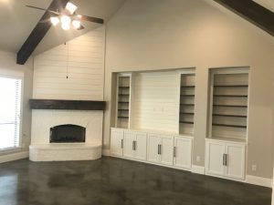 White Masonry Corner Fireplace with Built-Ins